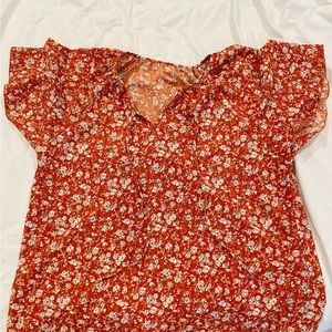 Orange blouse with white flowers